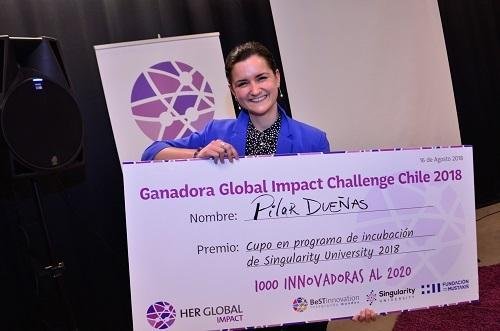Pilar Dueñas holding the Global Impact Challenge winner's cheque
